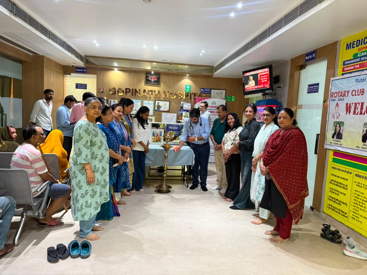Community members and hospital team gathered around a ceremonial lamp at Gopinath Hospital
