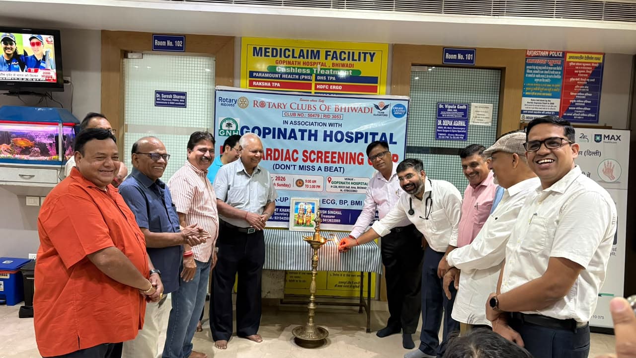 A doctor and Rotary Club members lighting a ceremonial lamp at Gopinath Hospital